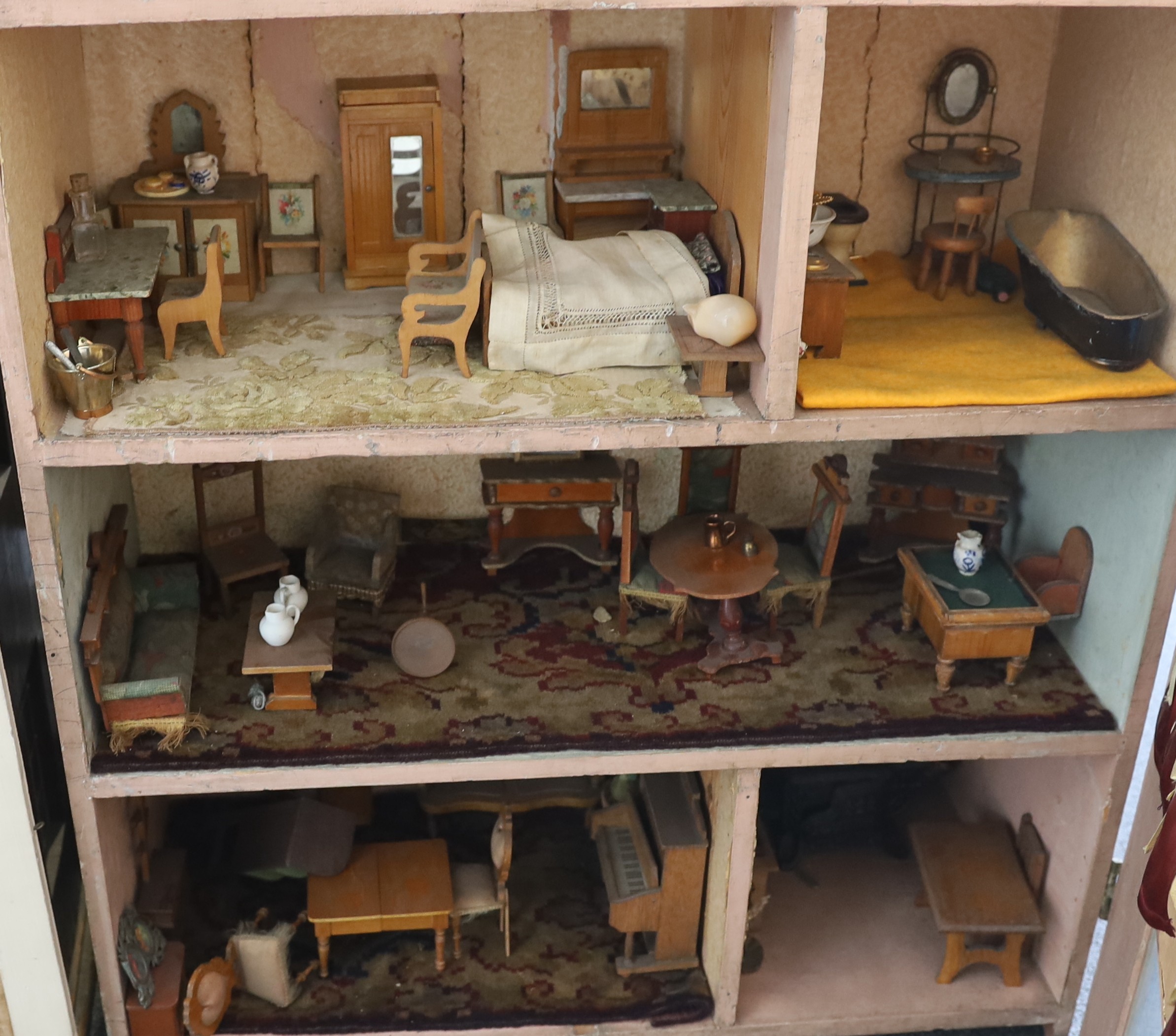 A Victorian furnished dolls’ house, circa 1890, 77cm high.